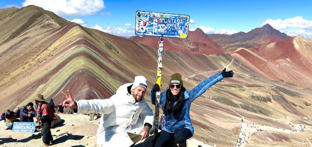 Rainbow Mountain summit view with travelers, a high point of altitude in Peru.