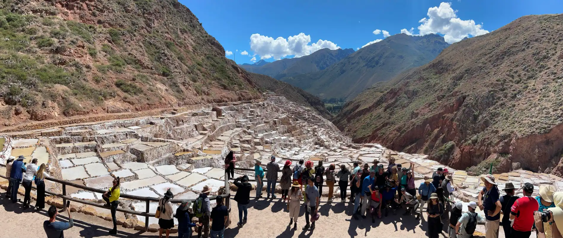 Panoramic view of the Salineras de Maras salt terraces in the Sacred Valley, Peru, with thousands of white salt pools cascading down the mountainside