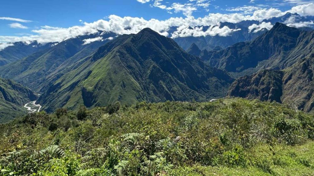 Lush green Andean mountain peaks and cloud forest valley along an Inca trail trekking route in Peru
